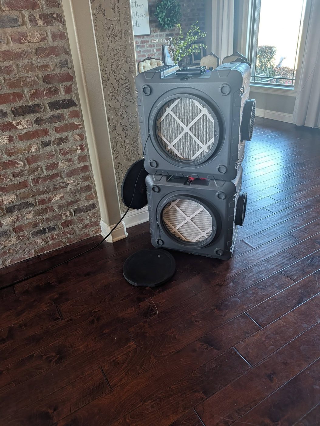 Air scrubbers used for indoor air quality service, set up in a living room
